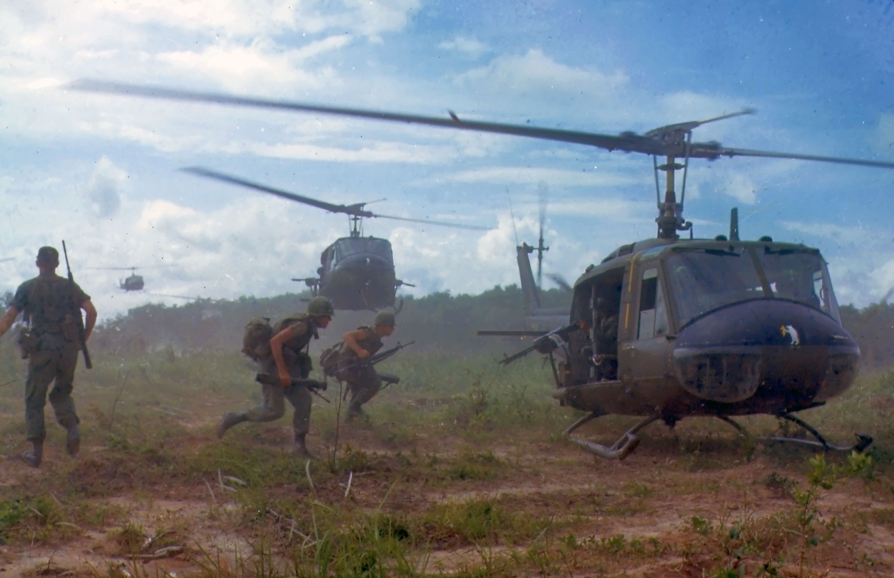 U.S. Army soldiers approach UH-1D helicopters near Cu Chi, South Vietnam, in 1966
